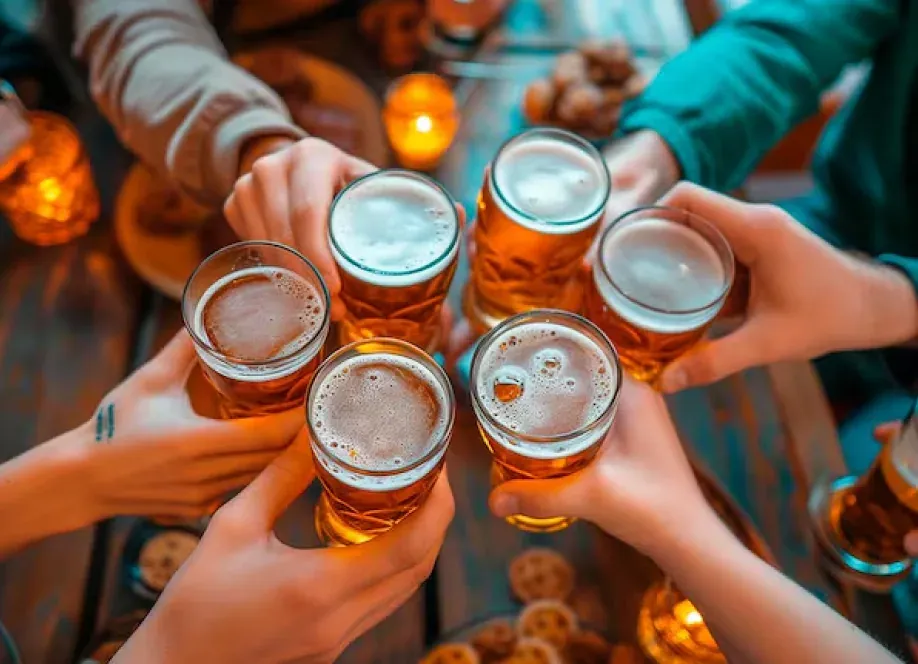 Friends toasting with glasses of Quilmes beer