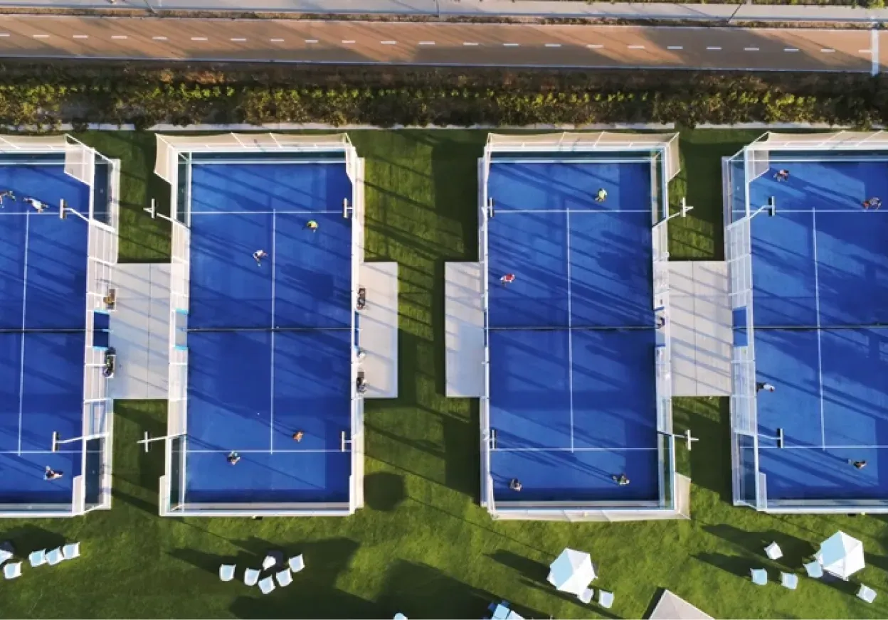 Aerial view of four blue padel courts