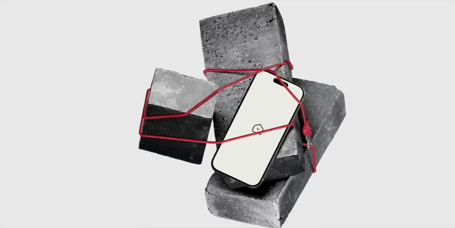 Smartphone tied with a red cord to raw concrete blocks