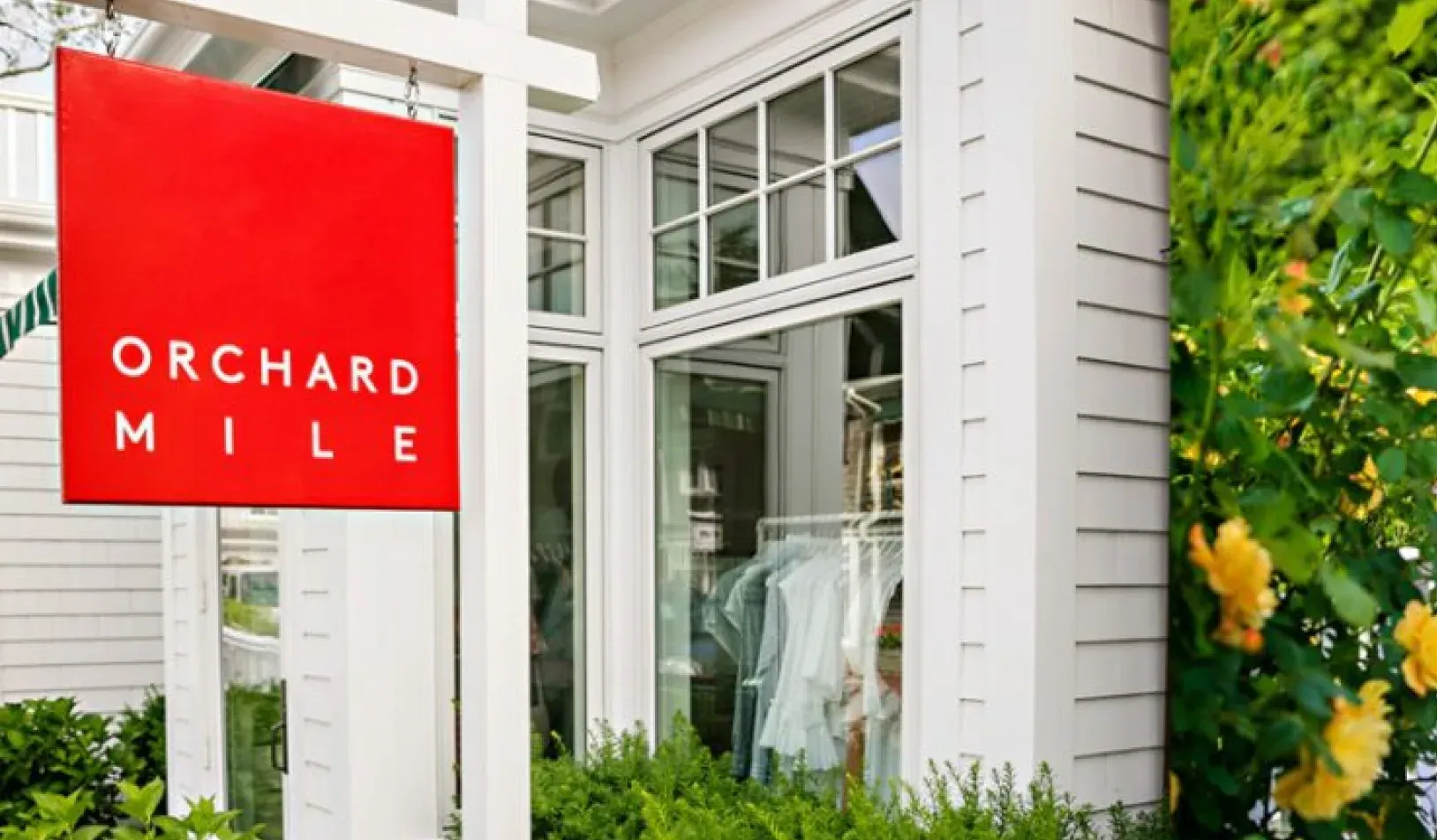 The Orchard Mile storefront sign outside a boutique